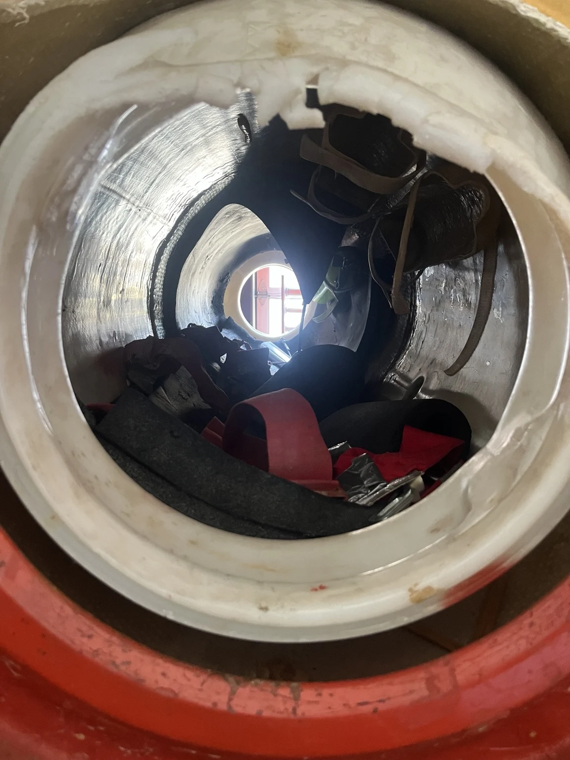 A close-up view inside a daredevil barrel, showing its padded interior and harnesses
